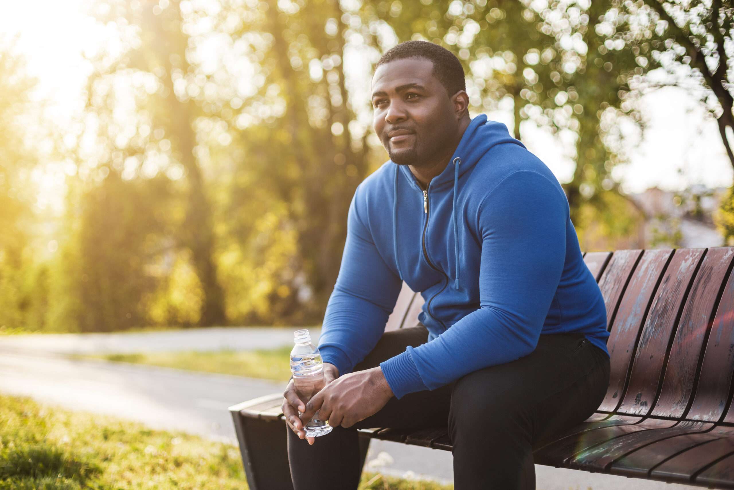 Man resting on bench after exercise